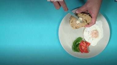 Still from the film showing a plate of breakfast and some hands