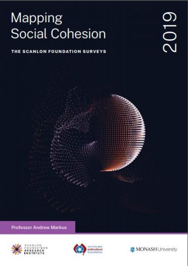 Cover of the Mapping Social Cohesion report showing a black background and a computer image of a ball distintegrating