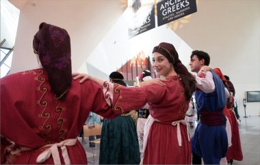 Greek community dancing in traditional attire at the opening of the exhibition