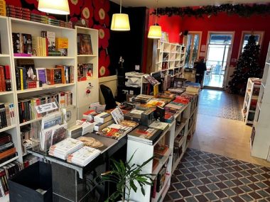 Interior of Books@Café with bookshelves and rugs and red walls