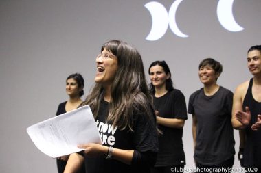 Group of actors in black t-shirts on stage