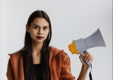 Young woman holding a megaphone