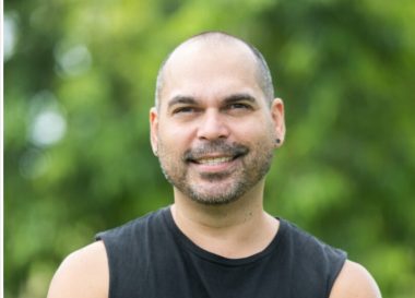 Ben Graetz wearing a black singlet against foliage