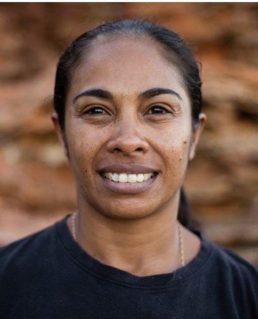 Dalisa Pigram against a backdrop of rock