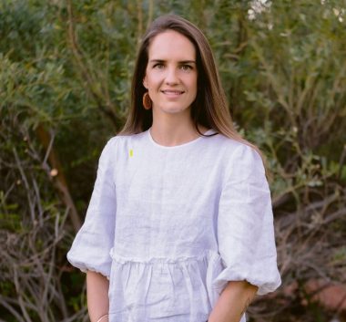 Dr LIlly Brown wearing a white shirt with long brown hair