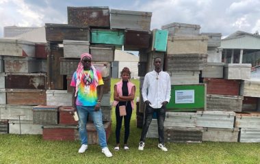 Artists Timothy Wandulu, Ingabire Umulisa and Heritier Mugisha standing in front of the art installation 